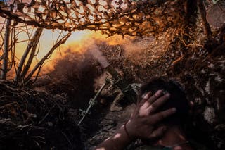 In this photo provided by Ukraine's 93rd Kholodnyi Yar Separate Mechanized Brigade press service, soldiers fire a mortar towards positions of Russian troops near Kostyantynivka in Donetsk region